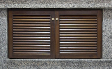 Wooden door and window shutter with louvers for background textu