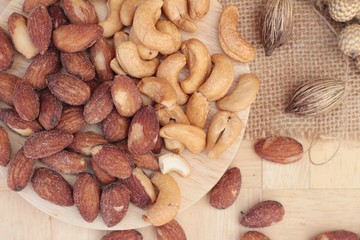 Almonds and cashew is delicious on wood background.