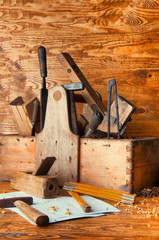 Equipment carpenter on a wooden desk with plans