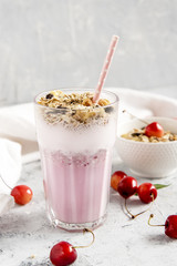 Mixed fruit smoothieswith granola. Summer and Healthy breakfast. Vertical photo.