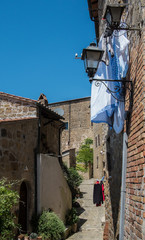 Washing hanging in a street in Sorano, Tuscany - 117835540