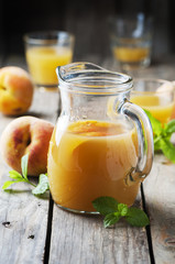 Fresh peach juice with mint on the wooden table