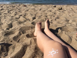 Sun sign on woman's legs
