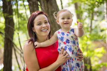 Mother and daughter in forest having fun