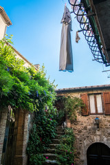 View upwards of washing in narrow street in Montemerano, Tuscany - 117836556