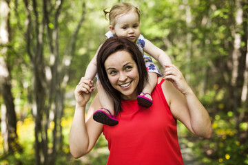 Mother and daughter in forest having fun