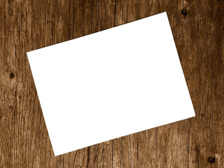 Blank white paper on blurred of wooden background