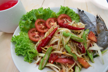 papaya and shrimp salad on white plate