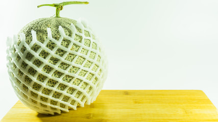 melon in fruit foam net on white background.selective focus