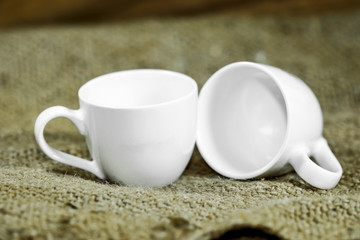 White coffee cup on a hemp sack.