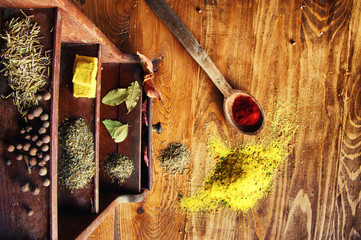 Spices lying on a small cabinet, view from the top