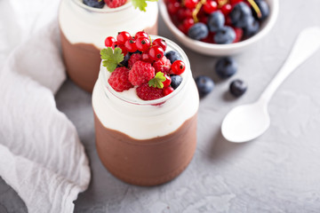 Chocolate pudding with cream and fresh berries