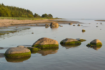stones at coastline at sunset