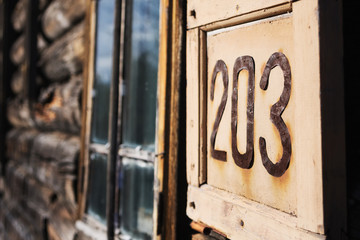 203 - Wooden sign with house number