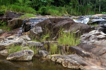 Naklejka na ściany i meble Waterfall in tropical forest.