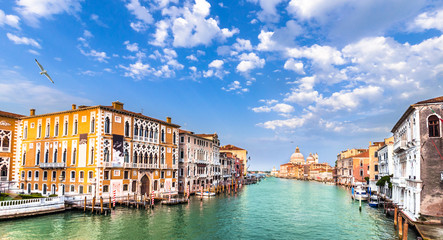 Gorgeous view of the Grand Canal and Basilica Santa Maria della Salute during sunset with...