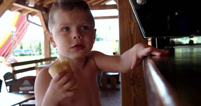 Portrait of Cute Boy Eating Ice Cream, Funny Child Busy With Dessert