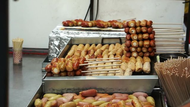Eomuk, Korean street food. Fried fish cake, sausage and hot dog on stick with red sauce in Seoul, Korea