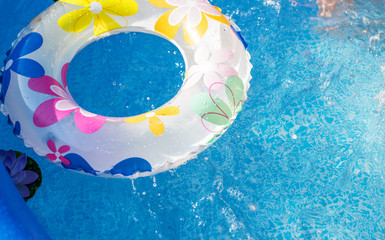 Inflatable swimming circle in open air pool in summer day
