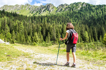 Young Woman doing hiking with trekking poles