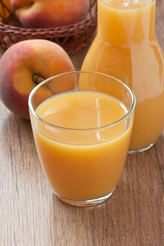 Peach juice drink / Glass fresh peach juice and ripe peach on wooden background