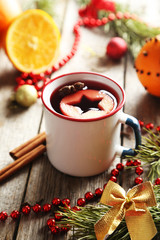 Mulled wine in cup on grey wooden table