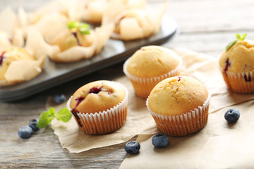 Muffins with blueberries on grey wooden table