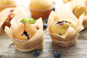 Muffins with blueberries on grey wooden table