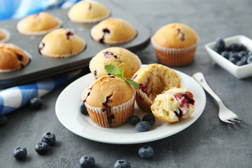Muffins with blueberries on a grey table