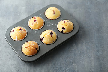 Muffins with blueberries on a grey table