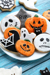 Fresh halloween gingerbread cookies on blue wooden table