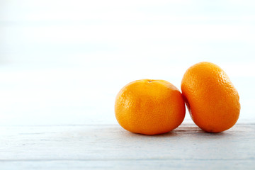Ripe mandarins on a blue wooden table