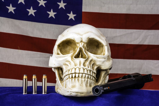 human skull on blue with three bullets and 357 magnum revolver and american flag background