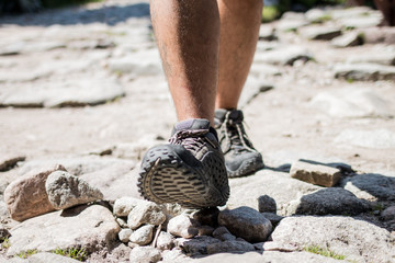 Man walking on the rocky path - front detail close up
