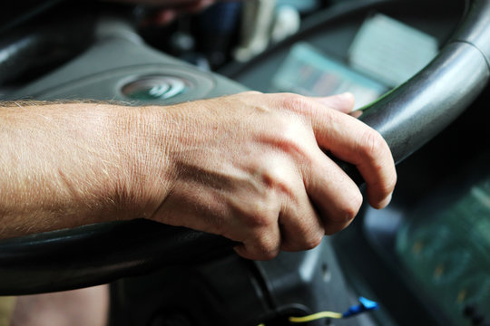 male hands of a large bus driver long haul.