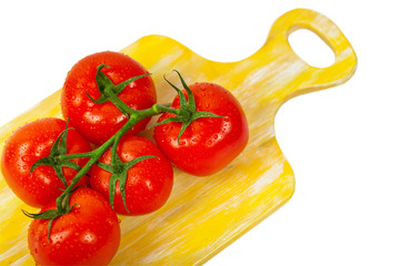 Red Tomatoes on the Vine Isolated on a white background. Selective focus.