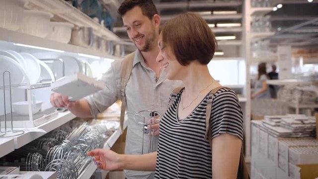 A newly married couple choosing stuff for the kitchen
