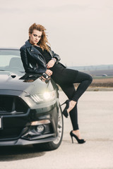 Beautiful woman posing by a sport car, new car concept