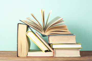 Open book, hardback books on wooden table. Education background. Back to school. Copy space for text.