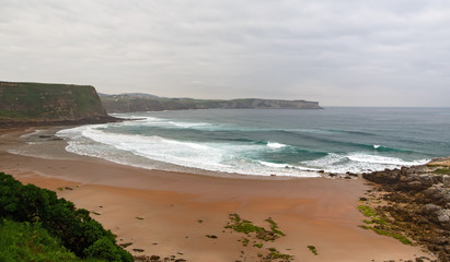 View of the sandy beach in cloudy foggy day