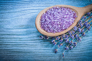 Composition of dry lavender scented sea salt wooden spoon on woo