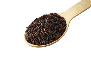 Black rice in a wooden spoon