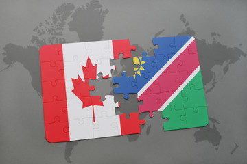 puzzle with the national flag of canada and namibia on a world map background.