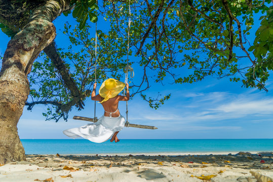 Woman swinging at the beach