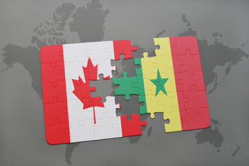 puzzle with the national flag of canada and senegal on a world map background.