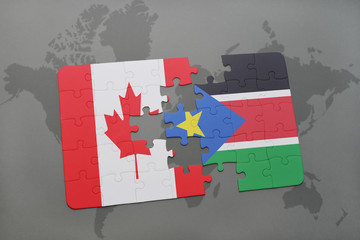 puzzle with the national flag of canada and south sudan on a world map background.