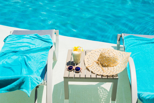 Swimming Pool Table With Sunglasses, Hat And Fresh Cocktail