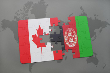 puzzle with the national flag of canada and afghanistan on a world map background.