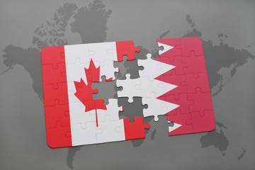 puzzle with the national flag of canada and bahrain on a world map background.