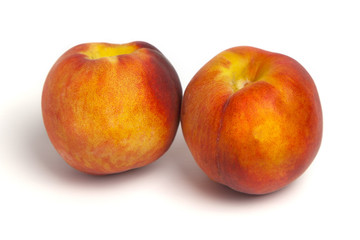 Fototapeta na wymiar Two peaches on a white background